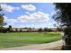 Expansive golf course view with rolling green fairway, desert landscaping, and bright blue sky with scattered clouds at 1227 E Sheena Dr, Phoenix, AZ 85022