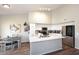 Bright kitchen featuring white cabinets, a large island, stainless steel appliances, and wood-look floors at 1227 E Sheena Dr, Phoenix, AZ 85022