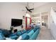 Bright open living room with vaulted ceilings, ceiling fan and modern decor adjacent to the dining area at 1227 E Sheena Dr, Phoenix, AZ 85022