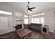 Cozy living room featuring a fireplace, hardwood floors, vaulted ceiling, and a leather couch at 1227 E Sheena Dr, Phoenix, AZ 85022