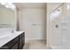 Bright bathroom with dual sinks, dark cabinetry, and walk-in shower at 1234 S Mullberry St, Florence, AZ 85132