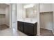 Elegant bathroom featuring dual sinks, dark wood cabinets, large mirror, and tiled floors at 1234 S Mullberry St, Florence, AZ 85132