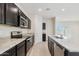 Modern kitchen with stainless steel appliances, granite countertops, dark wood cabinets, and tile flooring at 1234 S Mullberry St, Florence, AZ 85132