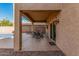 A covered back patio featuring a stylish dining set, tile flooring and a view overlooking the pool area at 13212 W Lisbon Ln, Surprise, AZ 85379