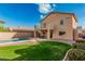 A single Gathering home backyard with a sparkling pool, patio, and grassy area at 13212 W Lisbon Ln, Surprise, AZ 85379