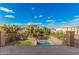 A balcony view overlooking a private backyard pool with lush landscaping and neighborhood homes beyond the fence at 13212 W Lisbon Ln, Surprise, AZ 85379