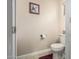 Cozy bathroom with tile flooring and a standard toilet, enhanced by a framed art piece on the wall at 13212 W Lisbon Ln, Surprise, AZ 85379