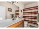 Bathroom featuring a large mirror over the double sink vanity and a striped shower curtain at 13212 W Lisbon Ln, Surprise, AZ 85379