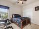 Bedroom with a ceiling fan, sliding closet, and a workspace with views of the community at 13212 W Lisbon Ln, Surprise, AZ 85379