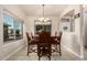 Charming dining room with chandelier, large window, and elegant wood table at 13212 W Lisbon Ln, Surprise, AZ 85379