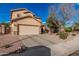 Inviting two-story home featuring a well-maintained front yard with desert landscaping and a two-car garage at 13212 W Lisbon Ln, Surprise, AZ 85379