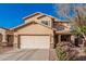 Inviting two-story home featuring a well-maintained front yard with desert landscaping and a two-car garage at 13212 W Lisbon Ln, Surprise, AZ 85379