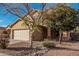 Inviting two-story home featuring a well-maintained front yard with desert landscaping and a two-car garage at 13212 W Lisbon Ln, Surprise, AZ 85379