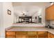 Open floorplan view from kitchen into the cozy living room with fireplace at 13212 W Lisbon Ln, Surprise, AZ 85379