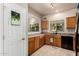 Bright kitchen with window, wood cabinets and view to a breakfast bar and living room at 13212 W Lisbon Ln, Surprise, AZ 85379