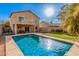 A sparkling backyard pool with a covered patio and second story balcony in a single Gathering home at 13212 W Lisbon Ln, Surprise, AZ 85379