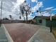 Backyard basketball court, block fence, green house, mature trees, and clear blue sky at 13805 N 31St Ave, Phoenix, AZ 85053