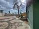 View of the basketball court and covered patio, backyard, and mature trees at 13805 N 31St Ave, Phoenix, AZ 85053