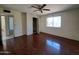 A bright bedroom with a window, ceiling fan, and closet at 13805 N 31St Ave, Phoenix, AZ 85053