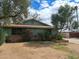 Front exterior of a single-story home adorned with mature trees and well-kept landscaping at 13805 N 31St Ave, Phoenix, AZ 85053