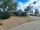 A single-story home framed by lush trees and a spacious front yard at 13805 N 31St Ave, Phoenix, AZ 85053