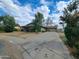 Charming single-story home featuring a spacious driveway, and mature trees at 13805 N 31St Ave, Phoenix, AZ 85053