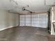 A large, empty garage featuring a roll-up door and concrete floors at 13805 N 31St Ave, Phoenix, AZ 85053