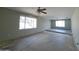 Spacious living room featuring two windows, a ceiling fan and a large open floor plan at 13805 N 31St Ave, Phoenix, AZ 85053