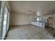 Large living area adjacent to a modern kitchen with a chandelier and patio doors for outdoor access at 13805 N 31St Ave, Phoenix, AZ 85053