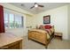 This bedroom features light walls, carpet, and a window with blinds for natural light at 14124 W Christy Dr, Surprise, AZ 85379