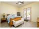 This bedroom features light walls, tile, and french doors leading outside at 14124 W Christy Dr, Surprise, AZ 85379