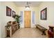 Welcoming foyer featuring tile flooring, decorative console, and ample natural light at 14124 W Christy Dr, Surprise, AZ 85379