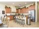 Spacious kitchen with granite countertops, stainless steel appliances, and a breakfast bar at 14124 W Christy Dr, Surprise, AZ 85379