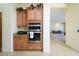 Kitchen featuring stainless steel double ovens, granite countertops, and wooden cabinetry at 14124 W Christy Dr, Surprise, AZ 85379