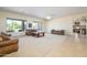 Open-concept living area with neutral tones, carpet flooring, and a view of the pool at 14124 W Christy Dr, Surprise, AZ 85379