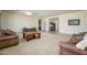 Spacious living room featuring neutral tones, plush seating, and ample natural light from large windows at 14124 W Christy Dr, Surprise, AZ 85379