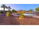 Sparkling pool surrounded by lush landscaping and a cozy bar, creating a serene backyard oasis at 14124 W Christy Dr, Surprise, AZ 85379