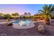 Backyard pool oasis featuring lush landscaping, umbrellas, lounge chairs, and a cozy bar, perfect for outdoor living at 14124 W Christy Dr, Surprise, AZ 85379