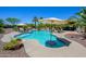 Stunning backyard pool with water features, in-pool table, and lush landscaping at 14124 W Christy Dr, Surprise, AZ 85379