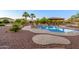 Private backyard oasis with a luxurious pool and covered patio area at 14124 W Christy Dr, Surprise, AZ 85379