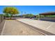 Spacious backyard sport court, mature landscaping, and outdoor living space at 14124 W Christy Dr, Surprise, AZ 85379