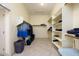 This walk-in closet features tile floors and shelving for storage at 14124 W Christy Dr, Surprise, AZ 85379