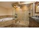 Elegant bathroom featuring a walk-in shower and a soaking tub at 14407 N 35Th Pl, Phoenix, AZ 85032