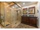 Elegant bathroom with a tiled glass shower, vanity with dual sinks, and tiled floors at 14407 N 35Th Pl, Phoenix, AZ 85032