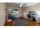 Bedroom with wood floors, ceiling fan, large window, and workout area at 14407 N 35Th Pl, Phoenix, AZ 85032