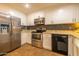 Modern kitchen featuring stainless steel appliances, granite countertops, and sleek cabinetry at 14407 N 35Th Pl, Phoenix, AZ 85032