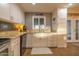 Well-lit kitchen featuring a stainless steel sink, granite counters, and white cabinetry at 14407 N 35Th Pl, Phoenix, AZ 85032