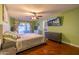 Cozy bedroom with hardwood floors, a ceiling fan, and sliding glass doors to the patio at 14407 N 35Th Pl, Phoenix, AZ 85032