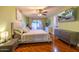 Cozy bedroom with hardwood floors, a ceiling fan, and sliding glass doors to the patio at 14407 N 35Th Pl, Phoenix, AZ 85032