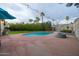 Backyard pool surrounded by concrete deck and lush greenery at 14407 N 35Th Pl, Phoenix, AZ 85032